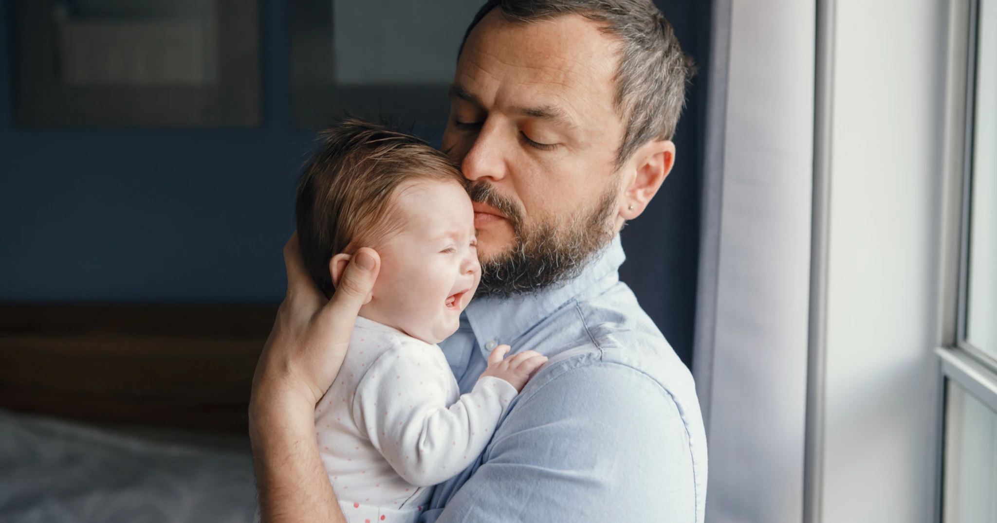 dad comforting his baby to sleep