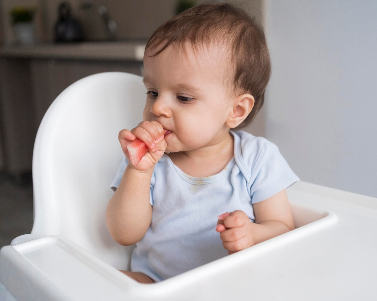 Baby chewing on a cold face washer for gum relief – teething baby sleep support